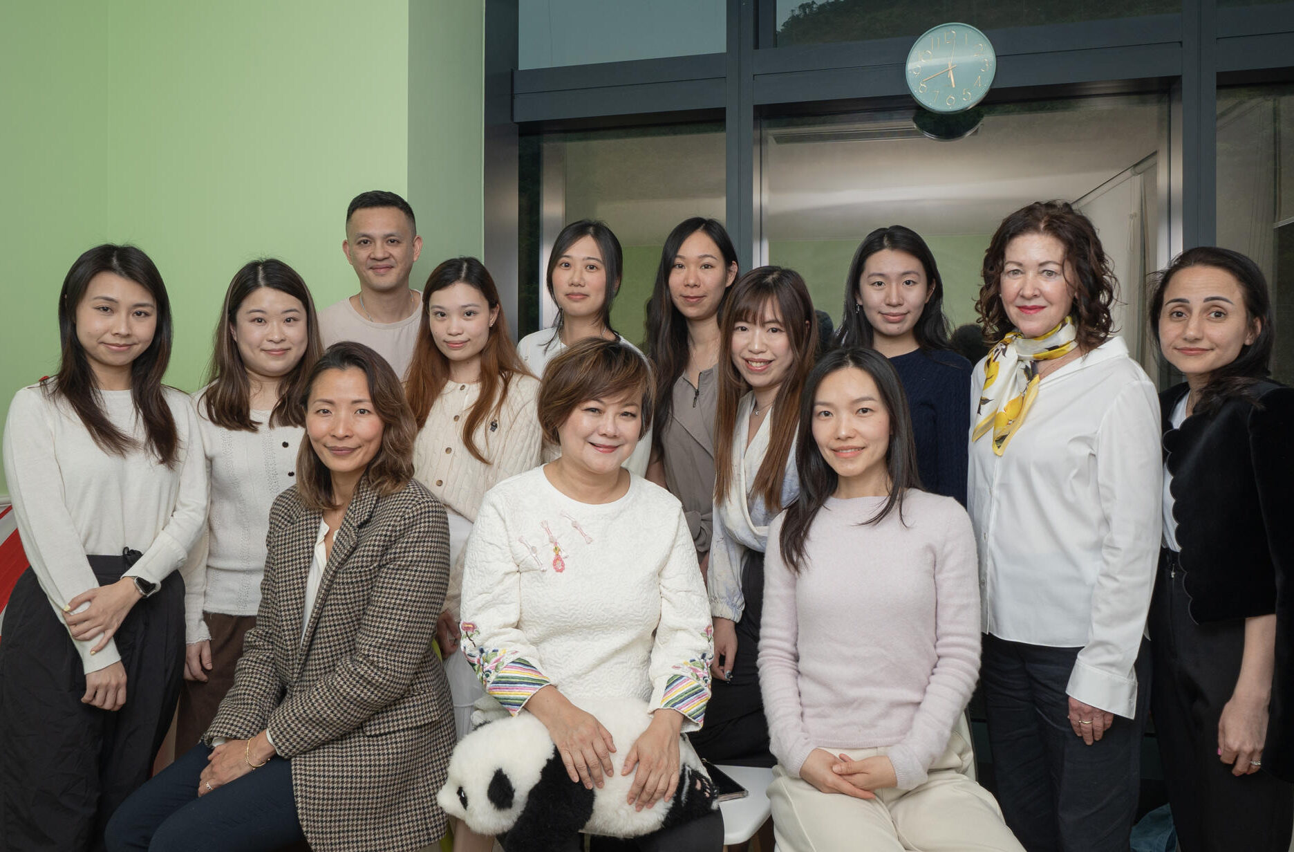 Sprout in Motion team photo with everyone facing the camera smiling in the ABA room. Clinical psychologist, Education psychologist, ABA behavioural therapist, Speech and language therapist, occupational therapist, admin staff, directors, customer service, psychometrists
